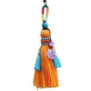 Bohemian handmade tassel keychain with orange fringe, blue beads, and purple crystals