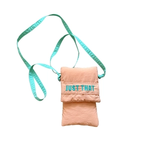 Cute pink and mint crossbody phone bag with Just That lettering on white background