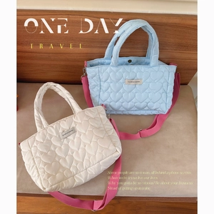 Quilted heart tote bags in soft blue and off-white with pink shoulder straps
