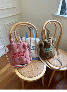 Three lamb wool tote bags in pink, blue and brown with wonder natural embroidery detail