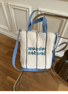 Detailed embroidery of wonder natural on soft beige fleece crossbody tote bag