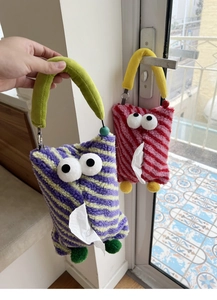 Detail of furry monster car tissue holders in purple and red stripes with big eyes