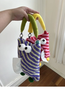 Detail of plush car tissue holder with cute big eyes and colorful striped teddy fleece