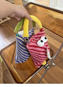 Close-up of colorful striped plush car tissue holders with quirky large eye decorations