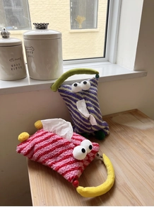 Macro shot of striped plush tissue holders with 3D eyes and soft contrast handles