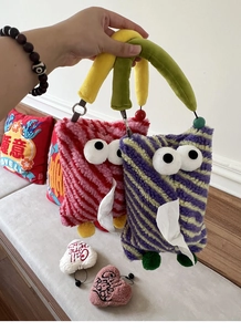 Detail of colorful striped plush monster car tissue holder with fuzzy handle