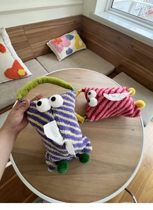 Detail of cute monster plush tissue holders in purple and pink striped soft fleece