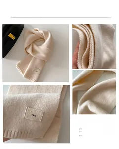 Detail of soft cream knit scarf showing fabric texture and emo patch decoration