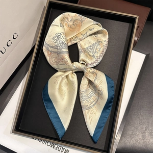 Elegant silk scarf with abstract geometric patterns on a luxury display tray