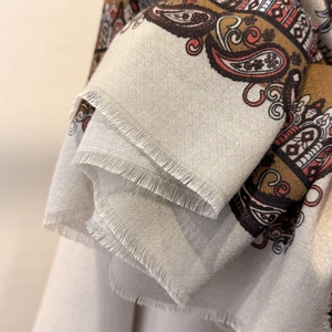 Close-up of paisley pattern and fine fringe edge detail on cotton linen scarf
