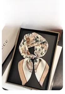 Detail of vintage floral print square scarf with silk-like texture and buckle pattern