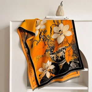 Winter floral jacquard scarf with magnolia design and fringe details on orange base