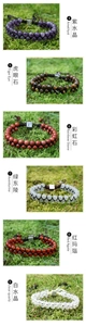 Detail of natural stone bracelets with amethyst, tiger eye, and silver spacers on moss