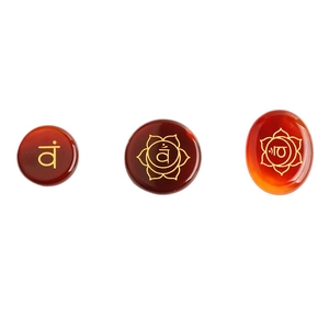 Red agate 7 chakra healing stones with gold symbols on a clean white background