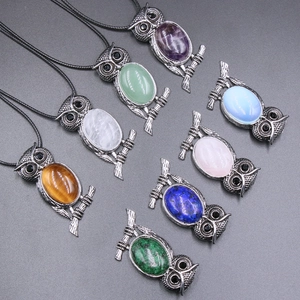 Collection of owl pendants with diverse gemstones like Tiger Eye and Amethyst in silver alloy