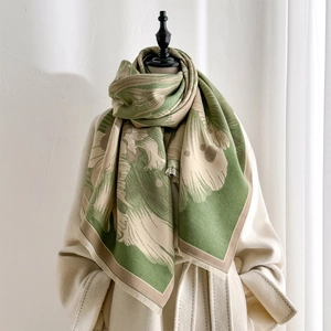 Green and beige vintage floral jacquard scarf with tassels on a wool coat