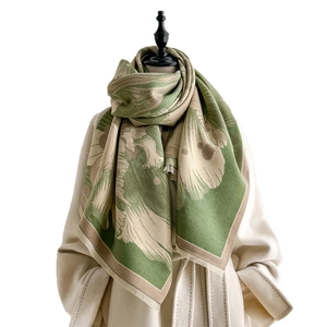Winter retro green floral jacquard scarf with fringe styled on a beige long coat