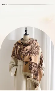 Detail of a thick winter scarf with vintage floral patterns and tassels on a mannequin