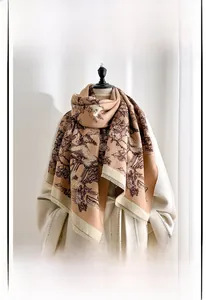 Detail of cashmere-like scarf with landscape print and tassels on a white coat