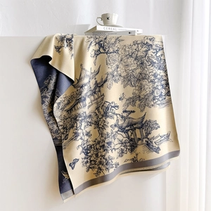 Detail of pashmina scarf featuring Chinese landscape print and fringe accents