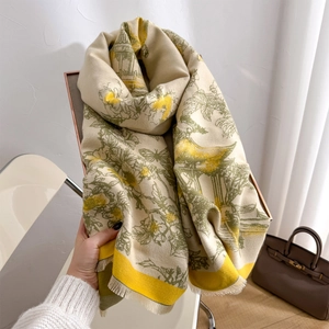 Macro detail of landscape pattern print and soft fringe edges on long cashmere-like scarf