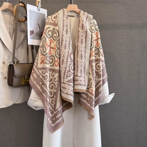 Detail of vintage geometric jacquard scarf with ethnic patterns and soft fringed edges