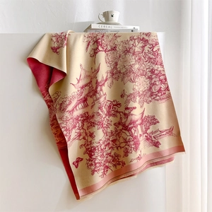 Detail of winter cashmere-like scarf with landscape print and delicate tassel edges