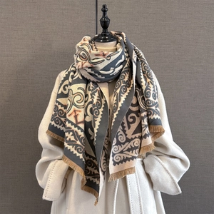 Close-up of vintage geometric jacquard scarf with thick texture and fringe on white coat