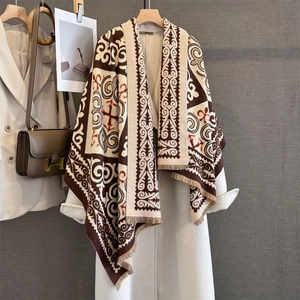 Detail of bohemian geometric jacquard scarf with fringe and vintage patterns