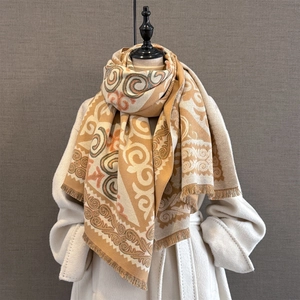 Detail of bohemian geometric pattern scarf with mustard fringe and ethnic jacquard texture