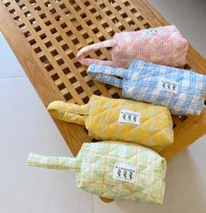 Quilted cotton cosmetics bags with checkered patterns in four vibrant pastel colors