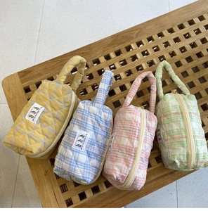 Close-up of quilted candy color cotton makeup bags with diamond lattice pattern