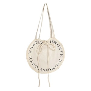 Minimalist round canvas shoulder bag with ribbon tie and black printed text