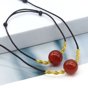 Handcrafted red agate bead necklaces with gold thread weave and brown cord