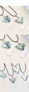Detailed close-up of fox-shaped shell pendants with colorful iridescent abalone texture