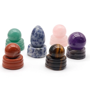 Assorted natural crystal gemstone spheres with matching round carved stone display bases