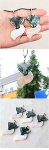 Detailed view of iridescent abalone shell fox pendant with elegant woven cord