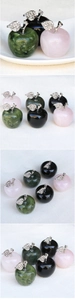 Close-up of pink quartz and green jade stone apples with decorative diamond silver leaves