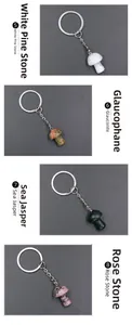 Detail showing four mushroom crystal keychains in turquoise, unakite, jasper and rhodonite