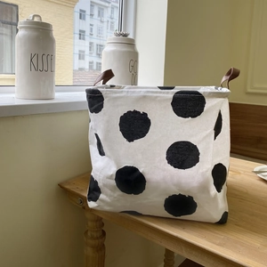 Foldable canvas laundry basket with black polka dots and brown PU leather handles