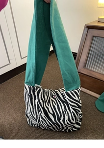 Borsa bento in tela zebrata con ampia tracolla verde e bottone a pressione in metallo