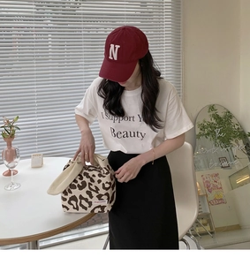 Detail of leopard print knitted tote bag with off-white handles and Augenstern brand tag