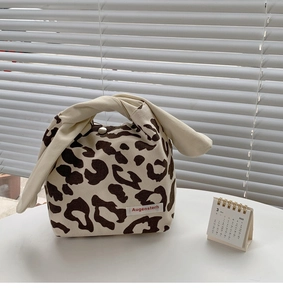 Detail of knotted handle and animal print canvas fabric on this stylish tote bag