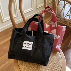 French style red and black tote bags with bow embroidery on a vintage chair