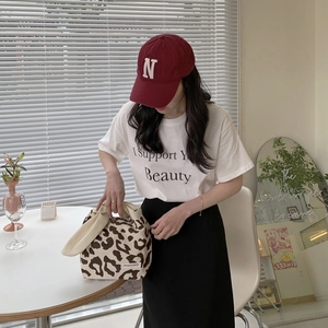 Japanese style leopard print fabric tote bag with casual outfit in cafe setting