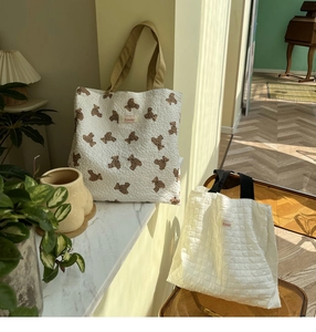 Detail view of Sonder large quilted tote bags with bear prints and waffle texture patterns