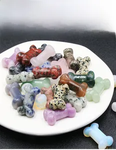 Macro detail of various natural crystal bone carvings in a white ceramic dish