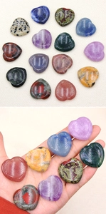 Detailed view of polished 30mm natural crystal heart stones in various gemstones