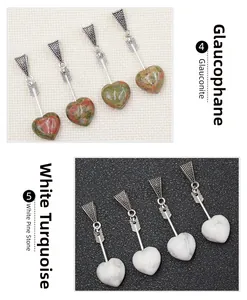 Macro detail of heart-shaped stone pendants with Cupid's arrow clasp in natural stone