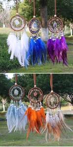 Macro view of six handmade dreamcatcher pendants with natural crystals and colorful feathers